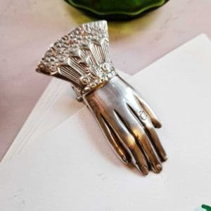 Vintage-inspired hand-shaped desk accessory, with detailed silver plating for organizing papers.